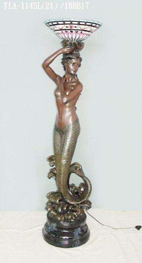 Mermaid floor lamp holding Tiffany glass lamp